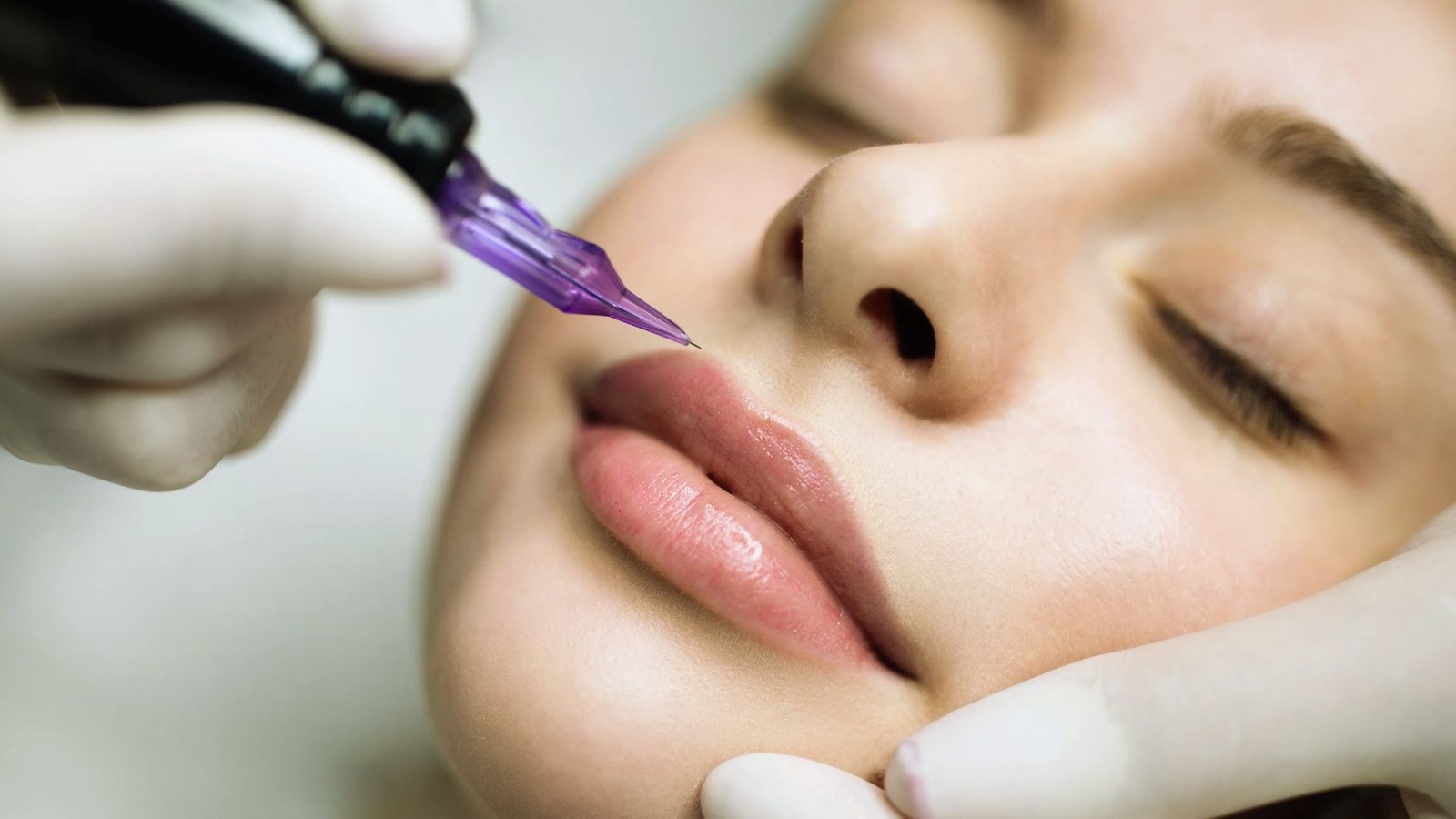 A woman undergoing a cosmetic lip enhancement procedure with a needle.