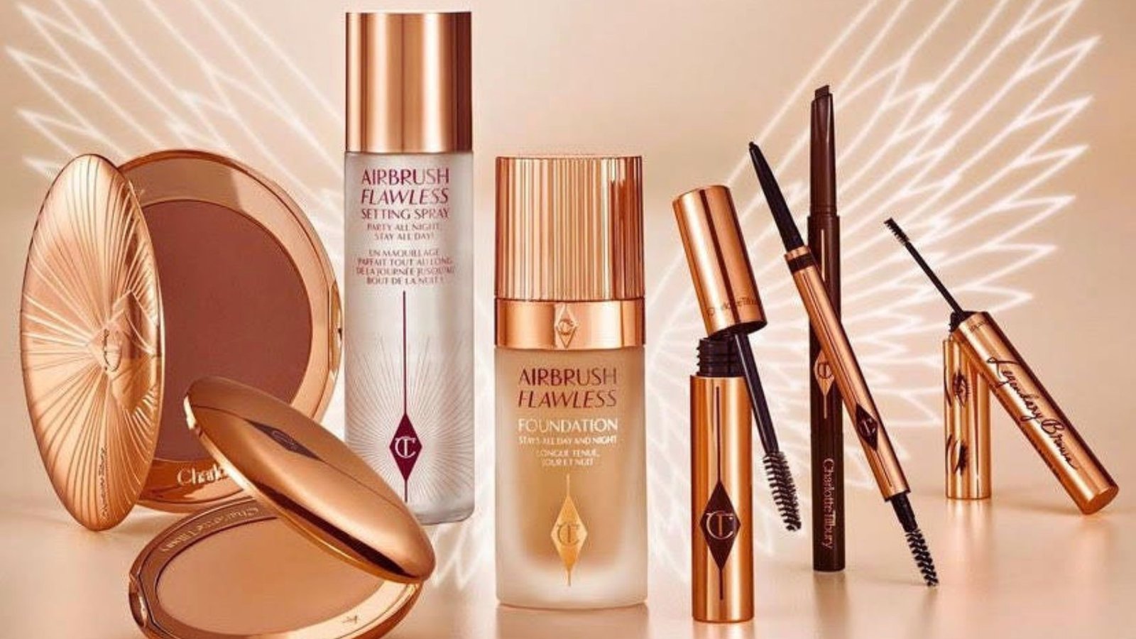 A display of makeup products arranged elegantly in a gold and silver setting.