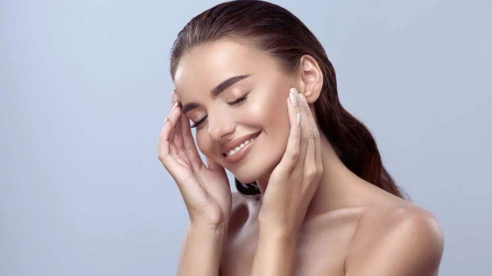 A woman covering her face with her hands, conveying a sense of shock or distress.