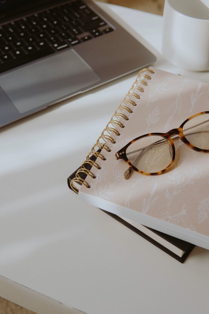 pair of glasses on a manifestation journal