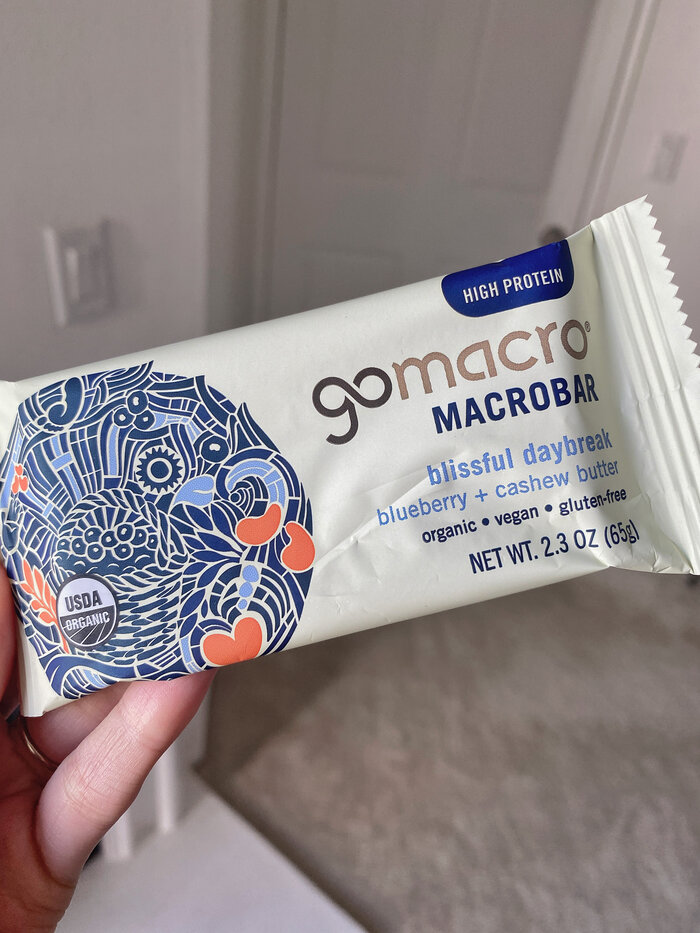 holding up a blissful daybreak gomacro bar