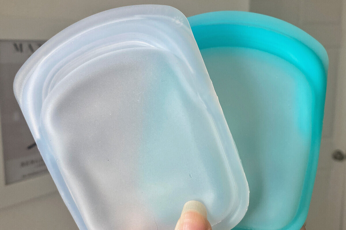 clear and teal Stasher bags against white wall