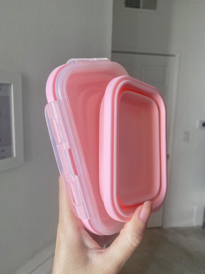 two pink collapsible food containers