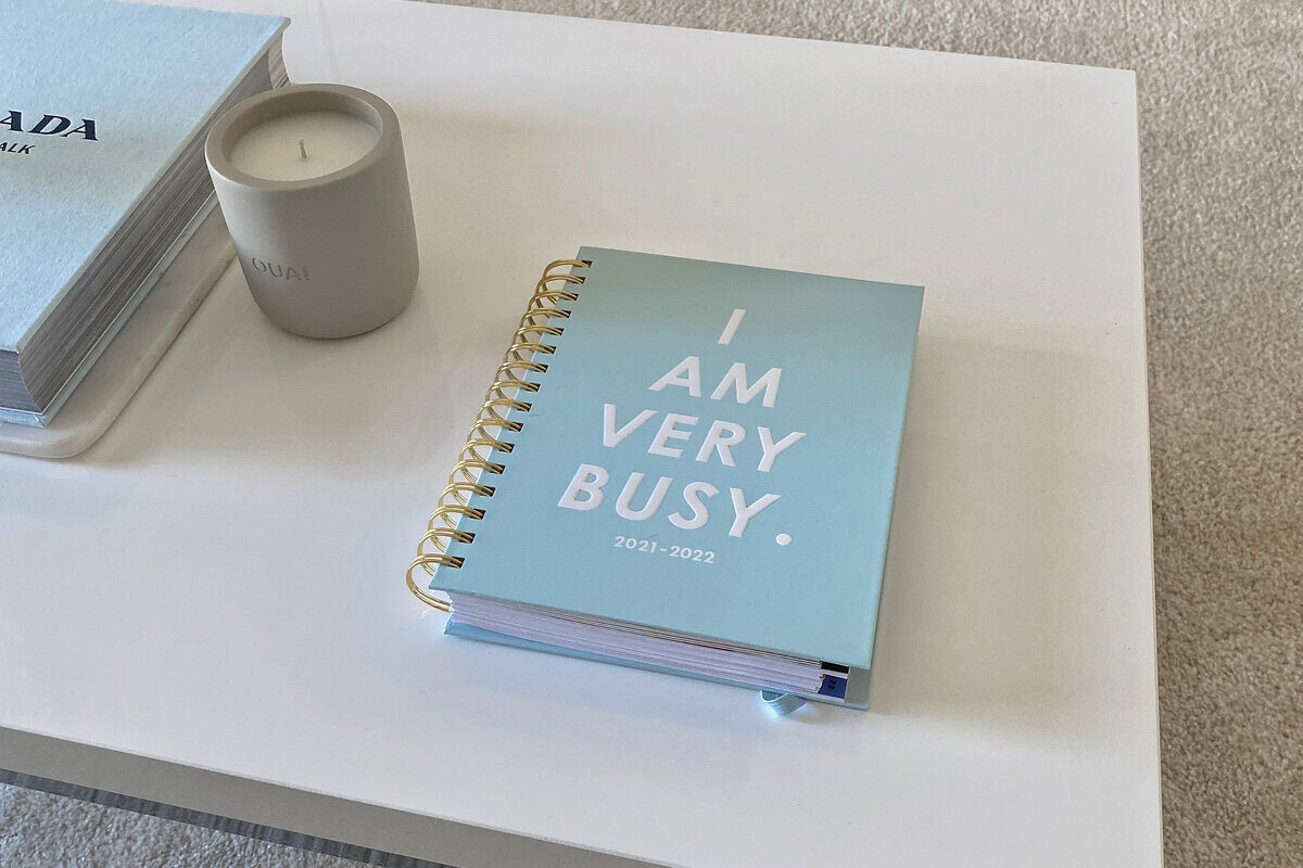 blue journal on white coffee table