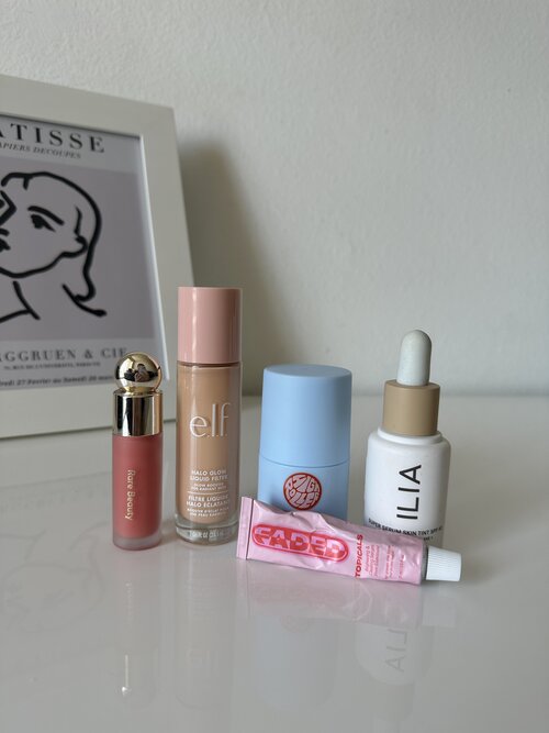 makeup products on white desk
