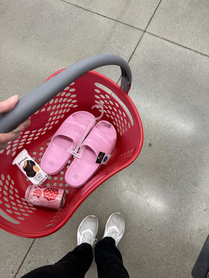 red grocery basket with products in it