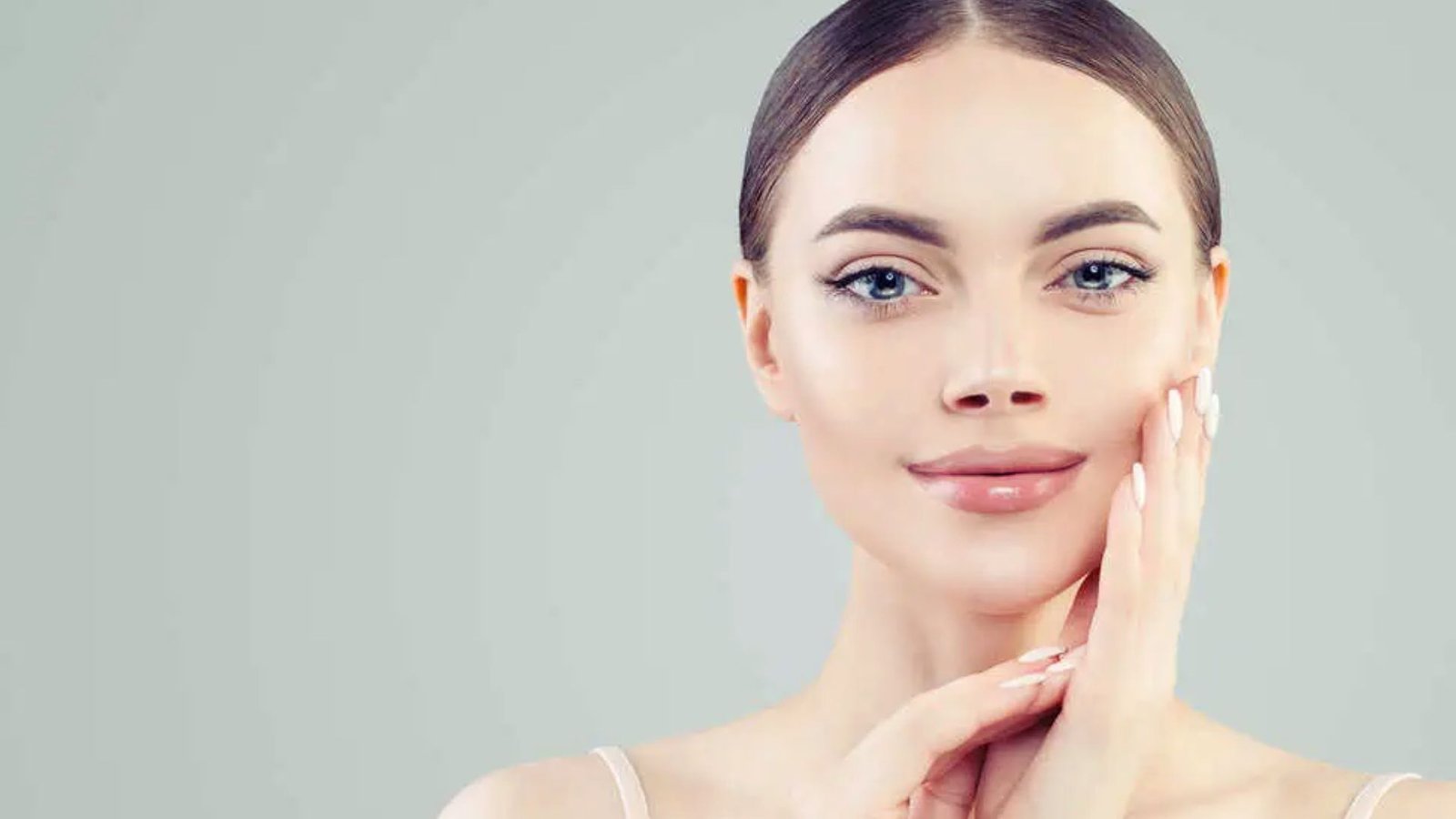 A woman covering her face with her hands, conveying a sense of shock or distress.