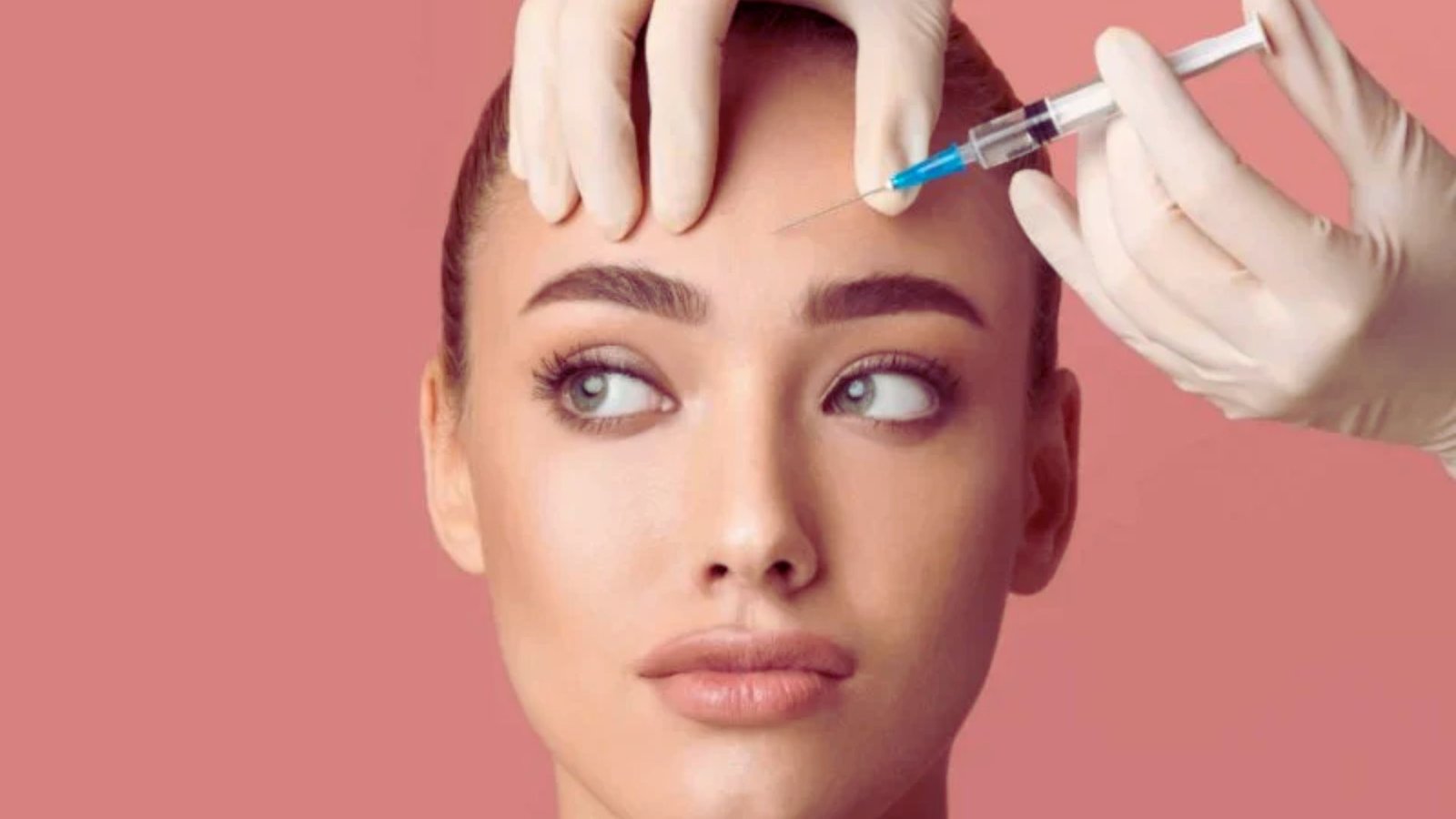 woman receiving a facial injection in a clinical setting, focused on her face and the medical professional administering it.