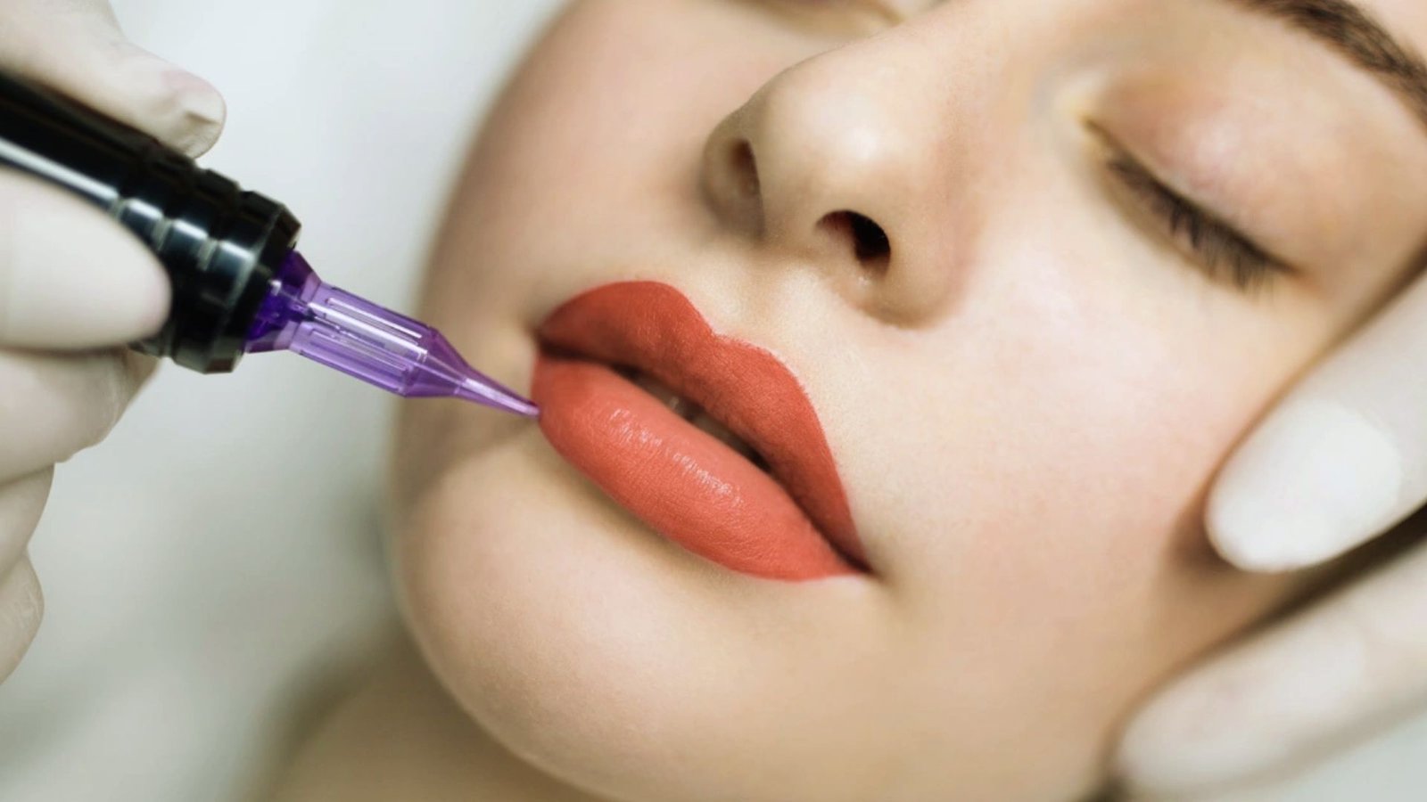 A woman undergoing a cosmetic lip enhancement procedure with a needle.