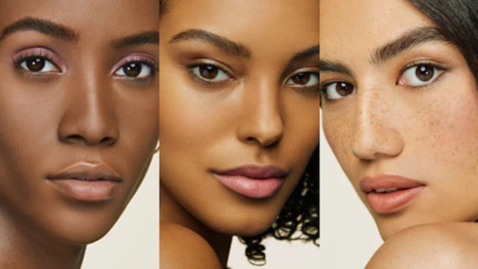 Four women of diverse skin tones stand together, showcasing a range of ethnicities and backgrounds in a harmonious setting.