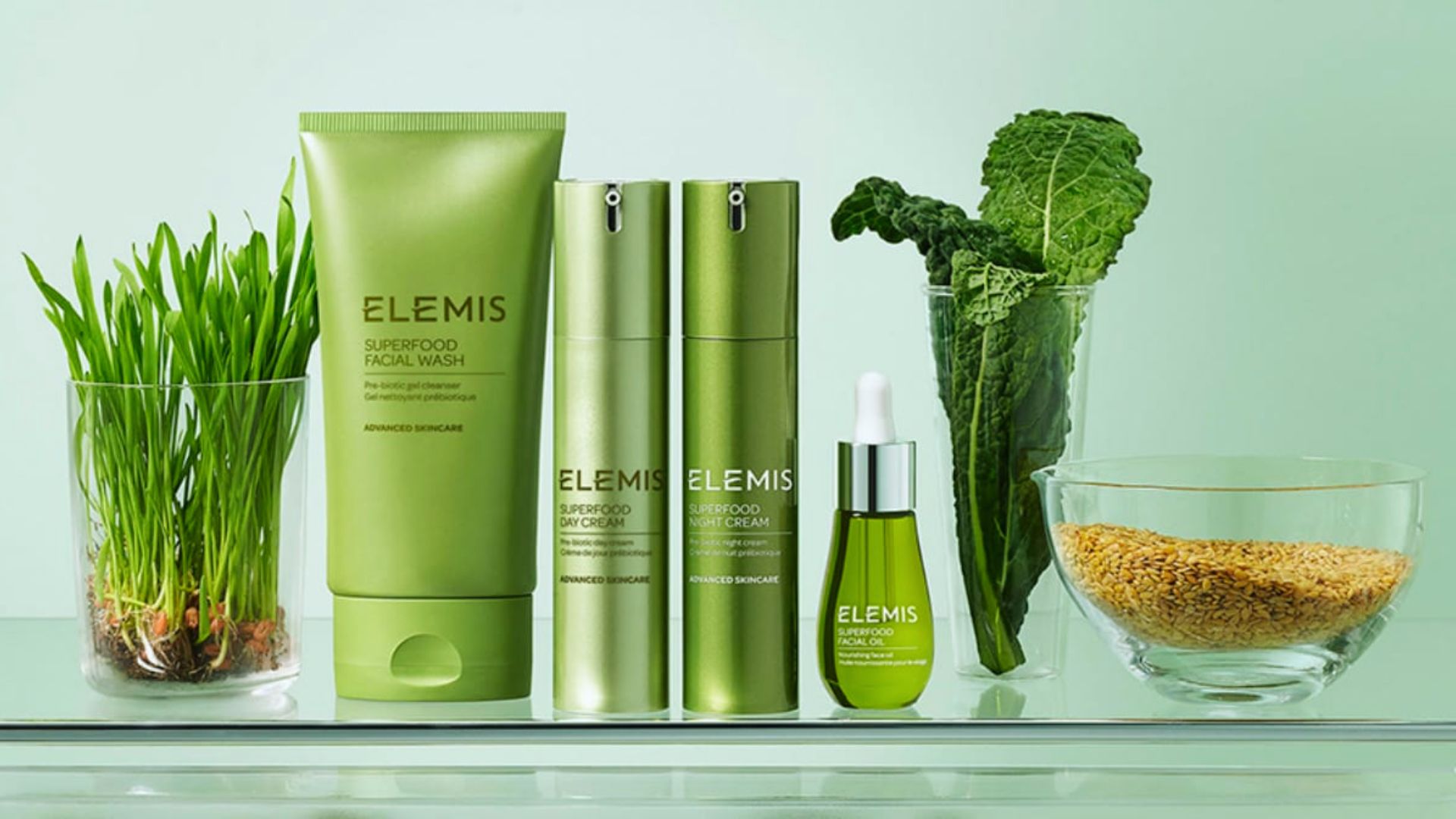 A selection of Elemis skincare products displayed neatly on a glass shelf.
