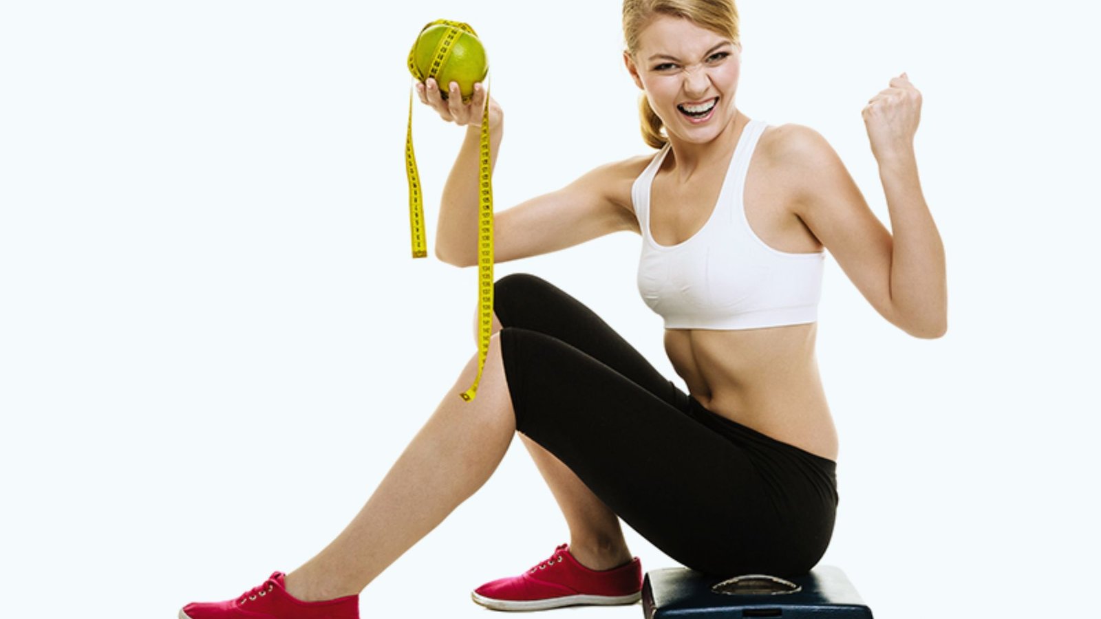 A woman sits on a scale, holding an apple, symbolizing health and wellness.