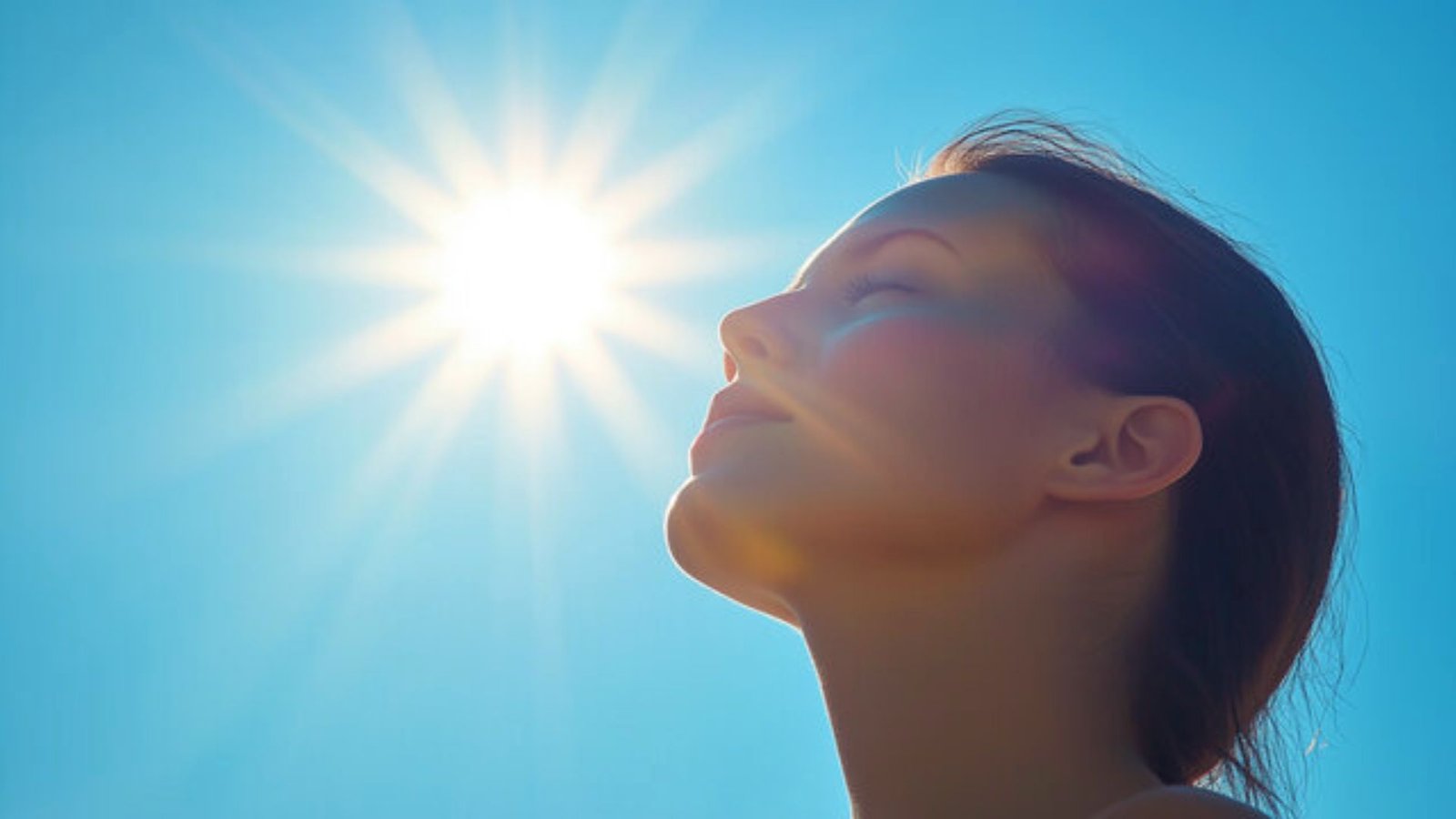 A woman gazes upward, shielding her eyes from the bright sun above her.
