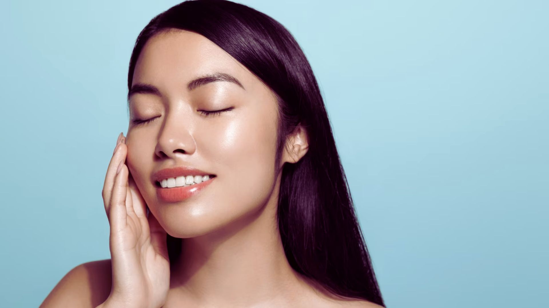 A woman with her hands on her face, expressing surprise or contemplation.