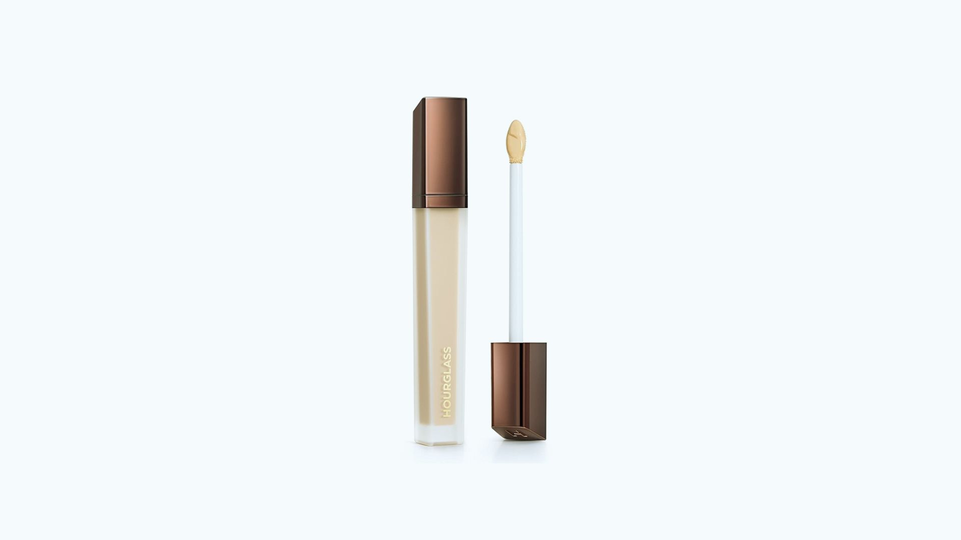 A brown tube of concealer with a white lid, showcasing its sleek design and compact size for easy application.