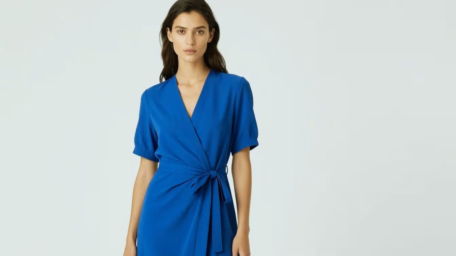A blue wrap dress displayed on a mannequin, showcasing its elegant design and flowing fabric.