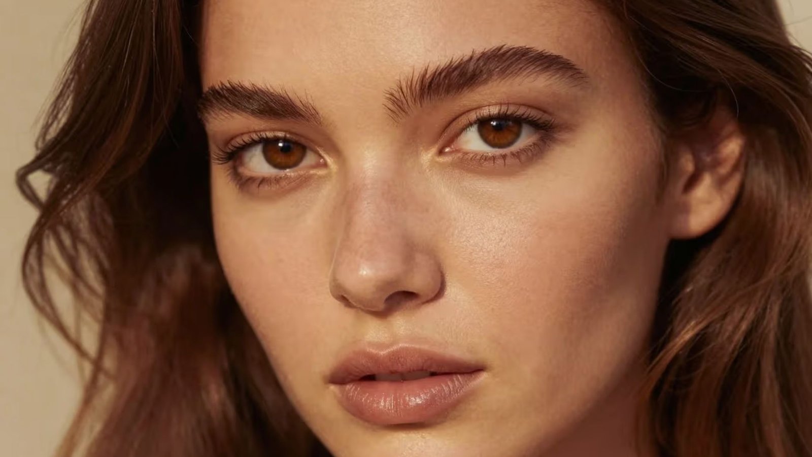 Close-up of a woman with brown eyes, showcasing her expressive gaze and natural beauty.