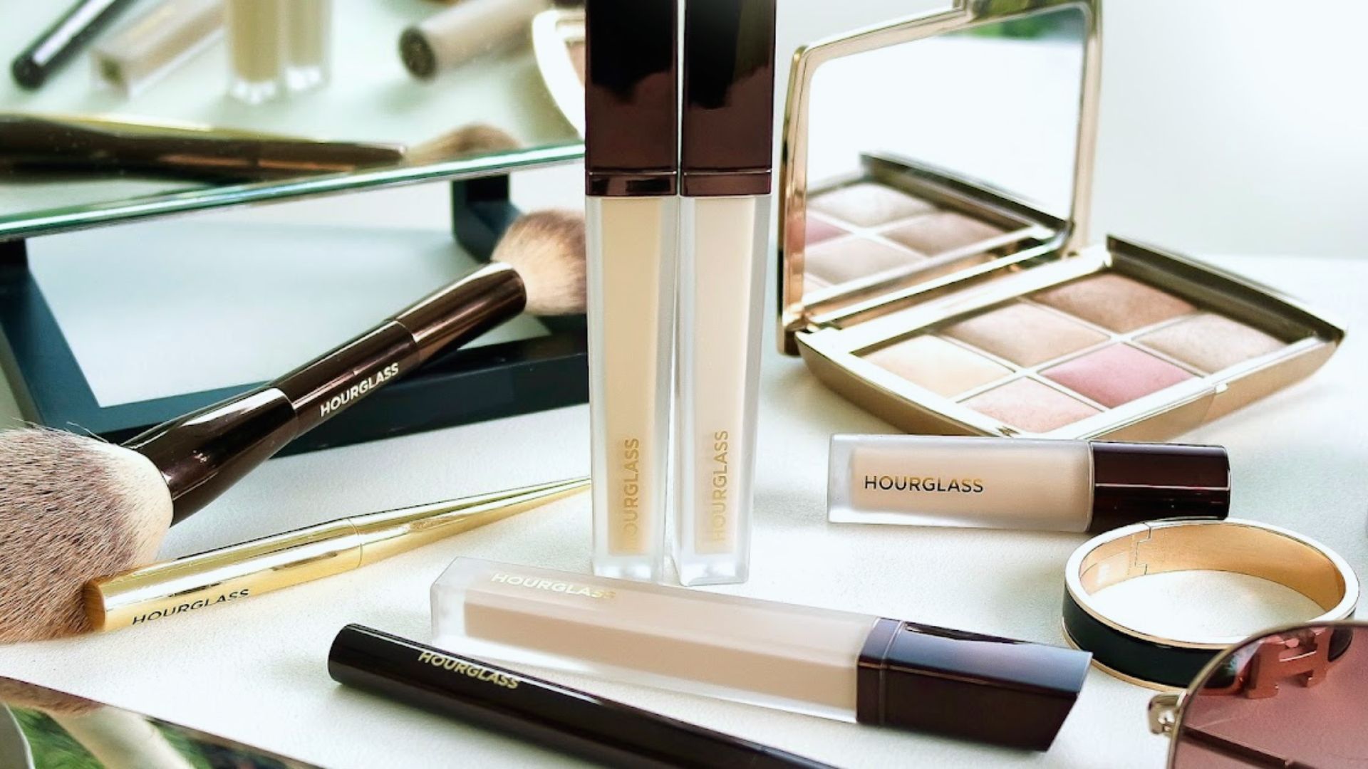 A variety of makeup products neatly arranged on a table, showcasing colors and textures for beauty enthusiasts.